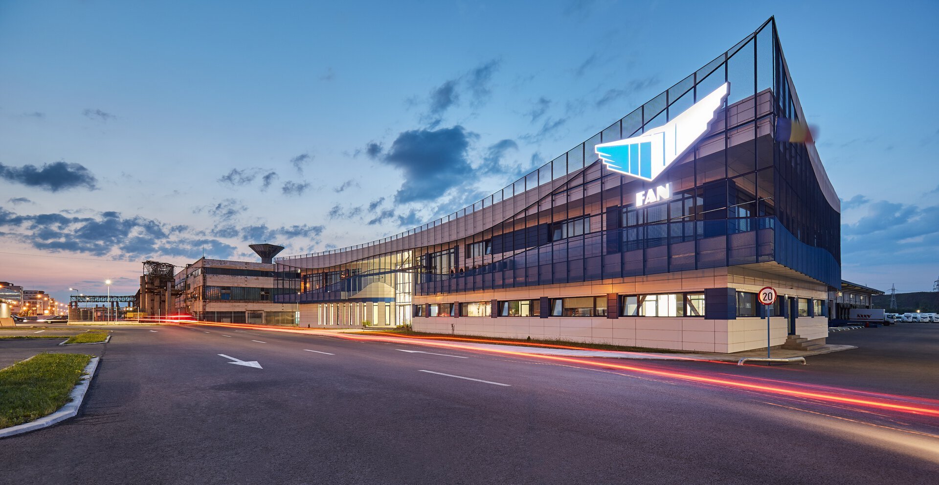 Two-storey reception hall, FAN Courier Brașov office building — grey granite, warm wood and blue joinery, project PPAE